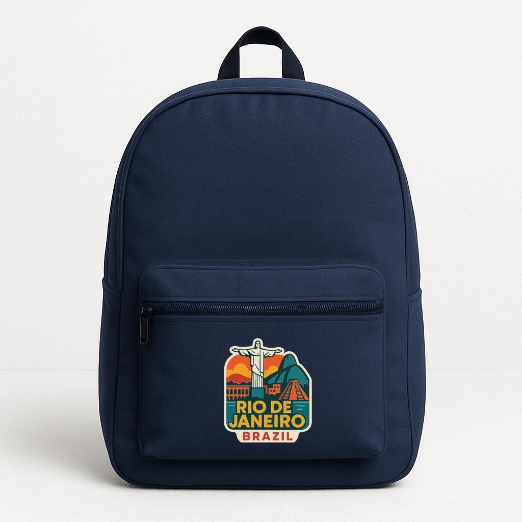 A navy blue backpack with a colorful graphic of the Christ the Redeemer statue in Rio de Janeiro, Brazil, and the text "Rio de Janeiro, Brazil" printed on it.