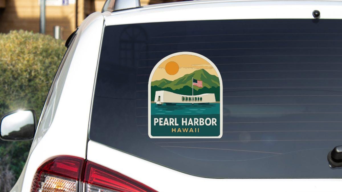 a sticker on the rear window of a car that displays the name "PEARL HARBOR" and "HAWAII", along with an illustration of the Pearl Harbor memorial.