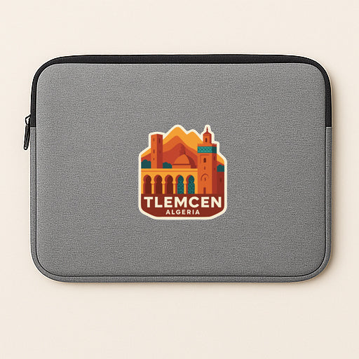 A gray laptop sleeve with a sticker depicting a cityscape and the text "TLECEN ALGERIA".
