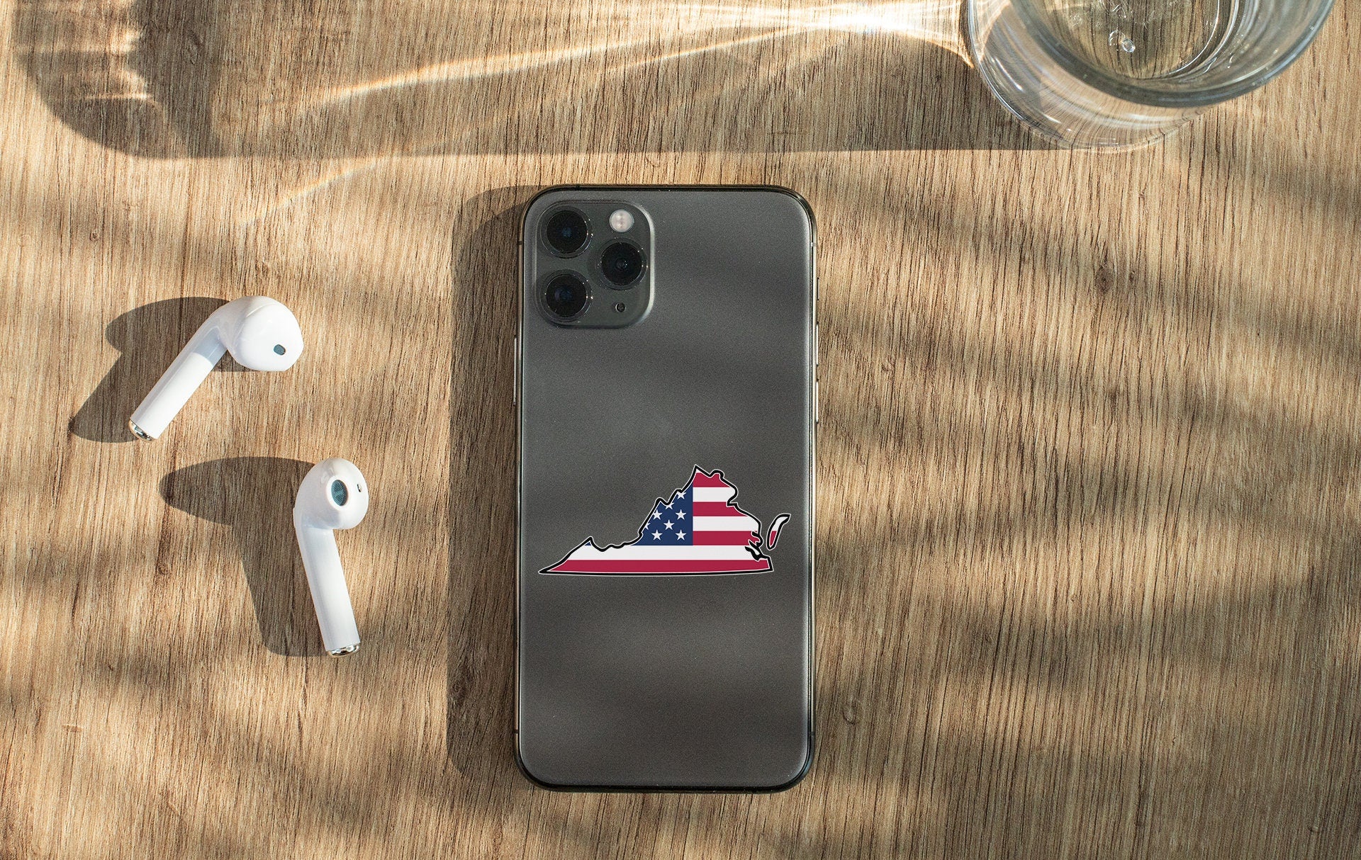 a cell phone with a sticker of a state with an american flag on it
