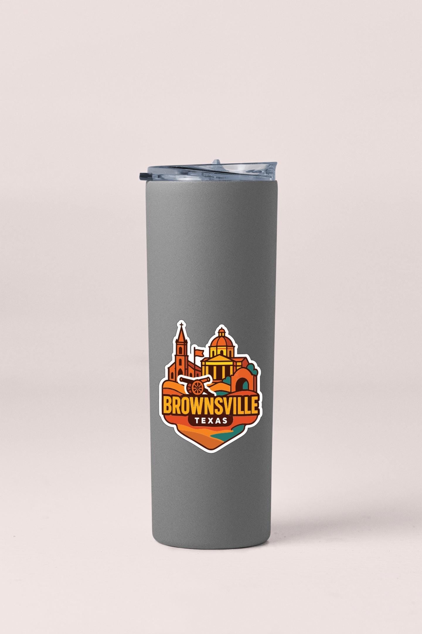 A gray insulated tumbler with a logo depicting the town of Brownsville, Texas.