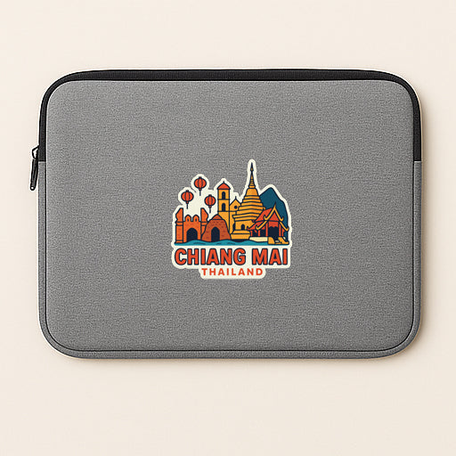 A gray laptop sleeve with a colorful graphic of the skyline of Chiang Mai, Thailand, printed on it.