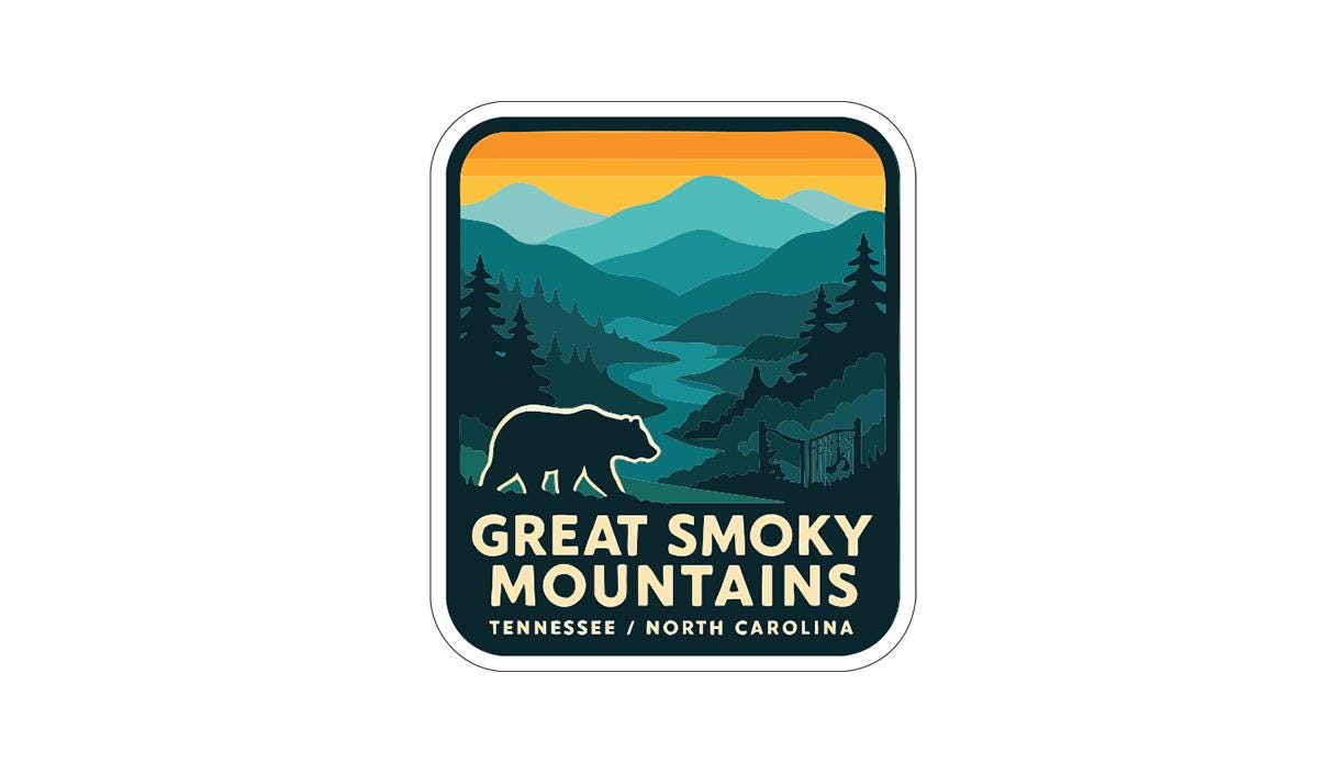 A sticker or logo featuring a bear silhouette against a mountain landscape with a sunset in the background.
