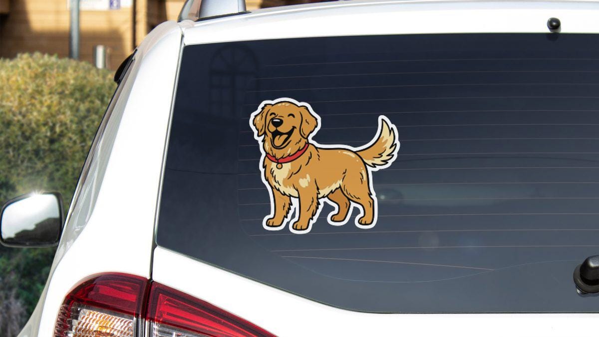 A sticker of a cartoon dog is on the rear window of a white car.