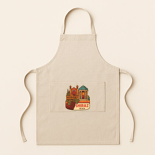 A beige apricot with a pocket on the front, featuring an illustration of a cityscape and the text "SHIRAZ" below it.