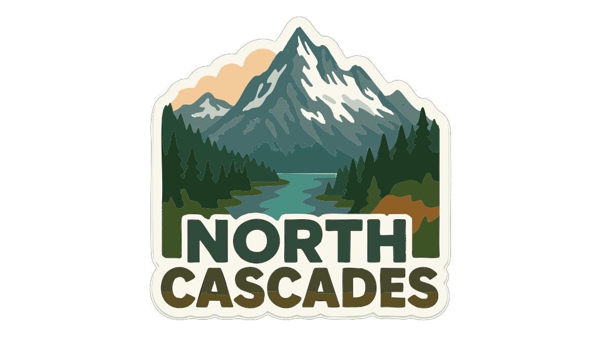 A sticker or logo featuring a mountain landscape with a river and pine trees, along with the text "NORTH CASCADES".