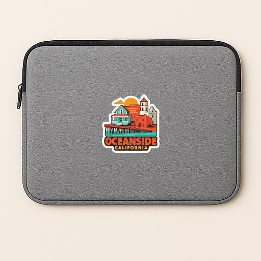 A gray laptop sleeve with a sticker depicting a coastal city scene and the text "OCEANSIDE CALIFORNIA".