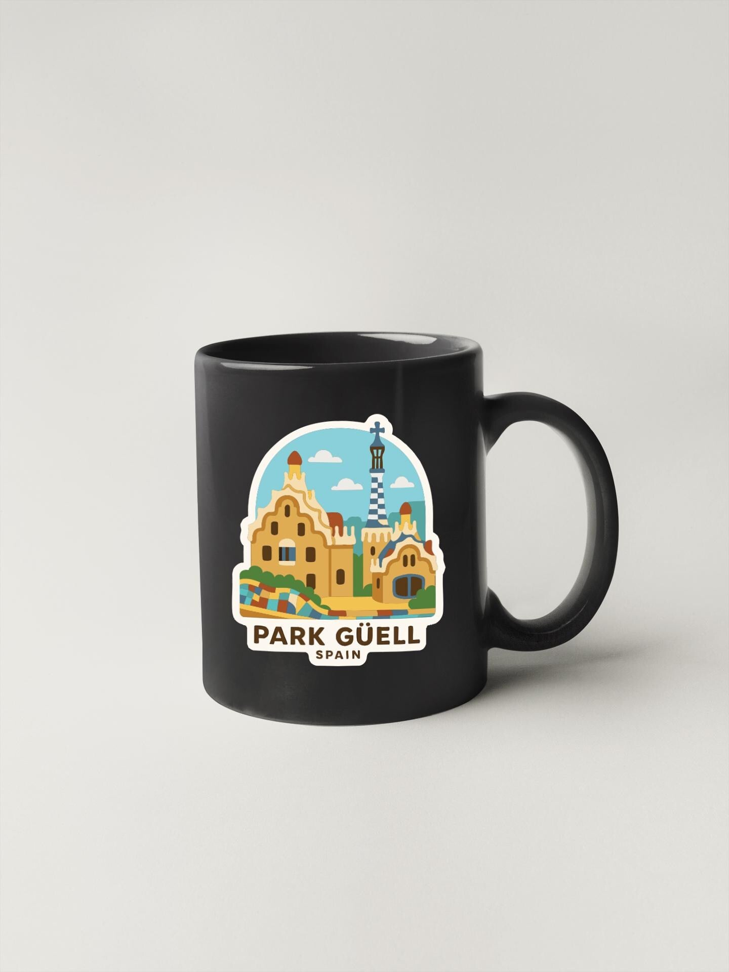 A black coffee mug with a graphic design depicting the Park Güell in Spain.