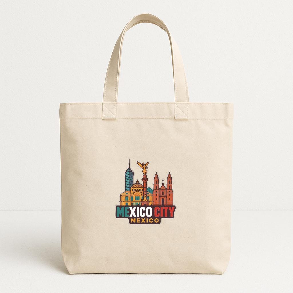 A beige tote bag with a colorful graphic of the Mexico City skyline printed on it.