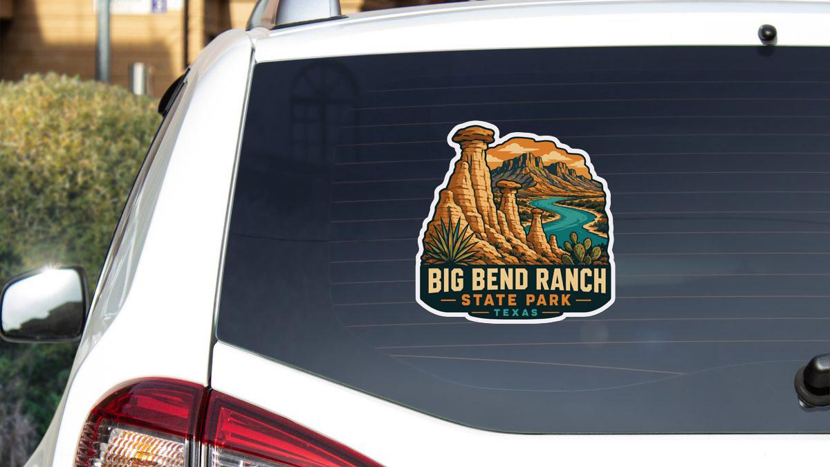 A sticker on the rear window of a white vehicle, depicting a scenic landscape with mountains, a river, and a desert-like environment.