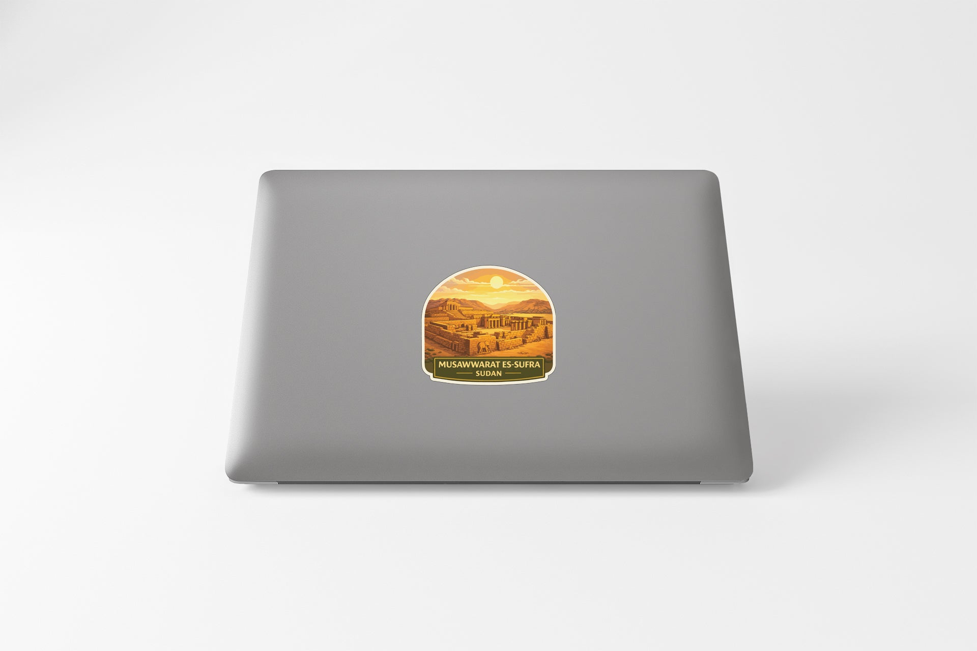 A sticker with a desert landscape on a laptop.