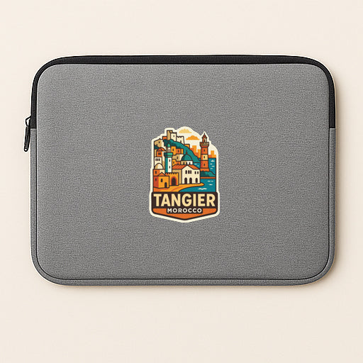 A gray laptop sleeve with a colorful sticker of Tangier, Morocco, printed on it.