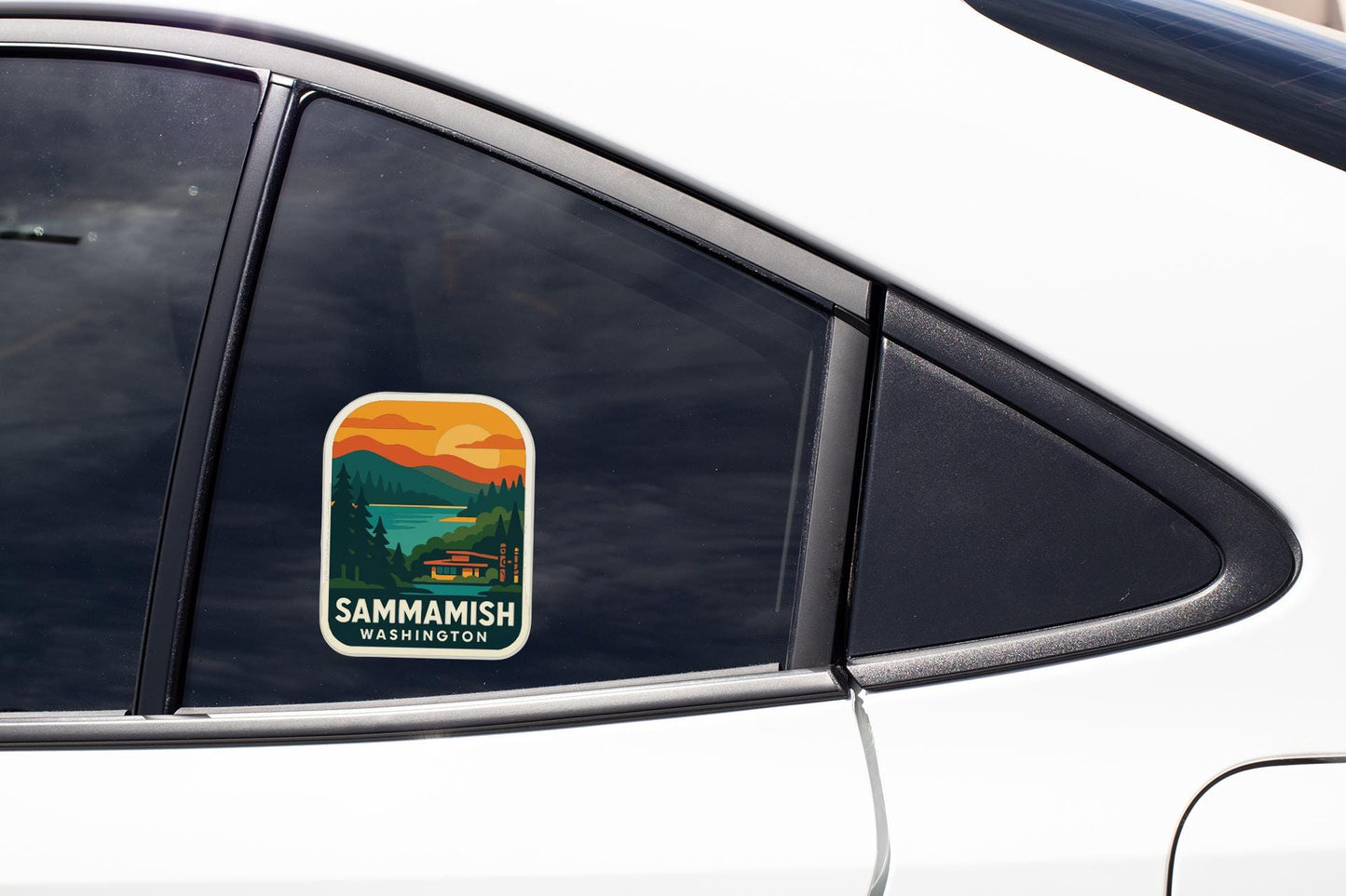 A sticker on the side of a car window, depicting a scenic landscape with mountains and a lake.