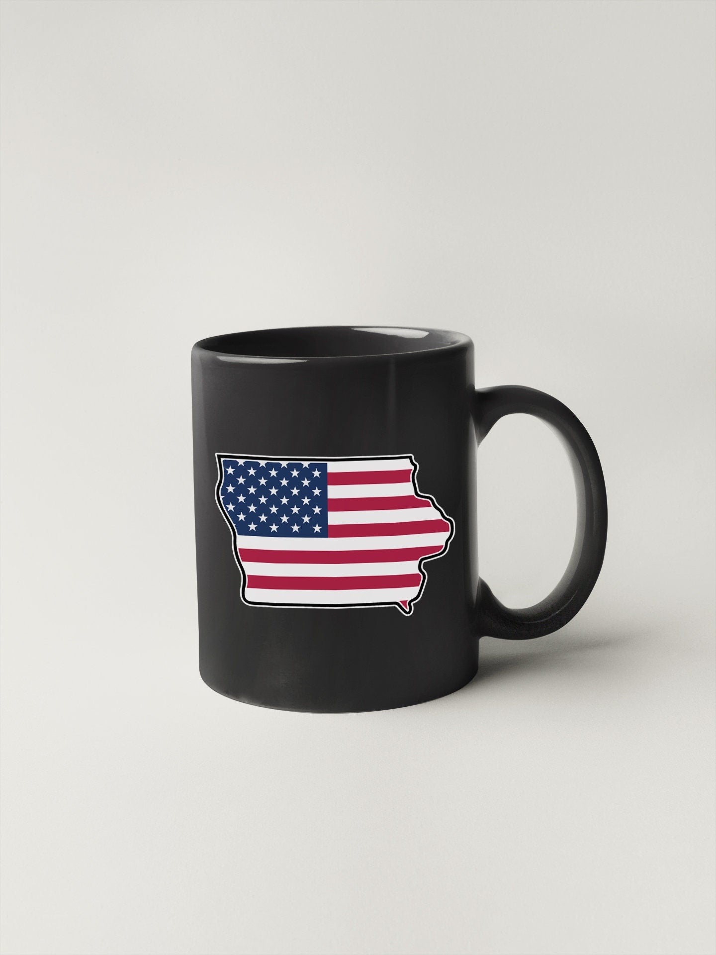 a black coffee mug with an american flag on it