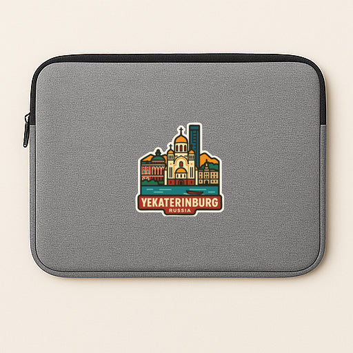 A gray laptop sleeve with a sticker depicting the city of Yekaterinburg, Russia.