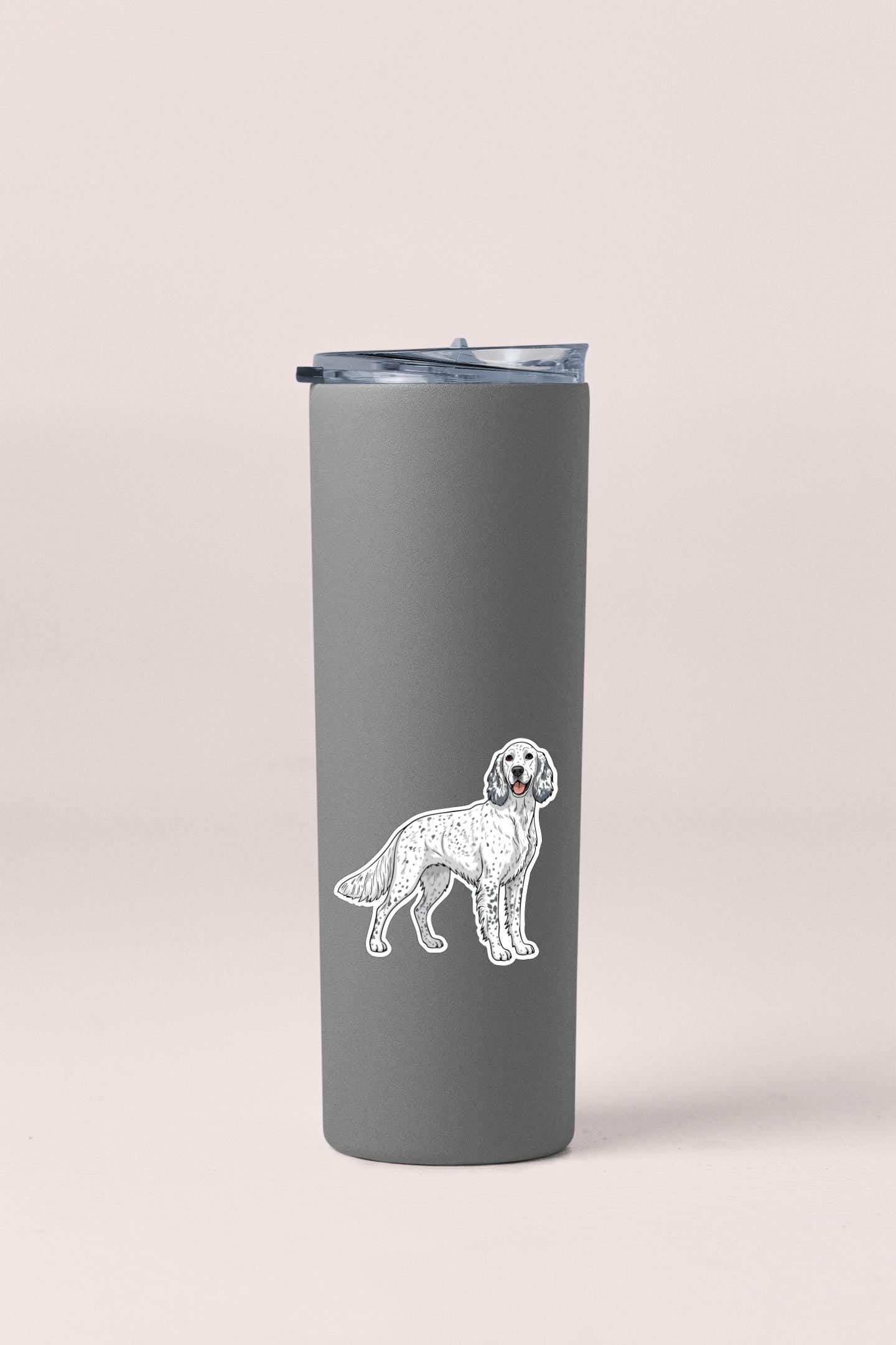 A gray insulated tumbler with a sticker of a dog on it.
