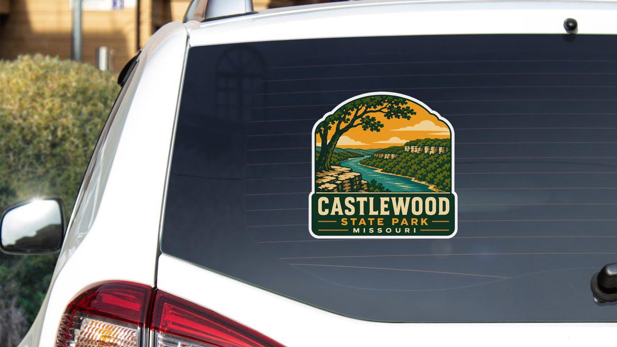 A sticker on the rear window of a white vehicle, depicting a scenic landscape with a river and mountains.