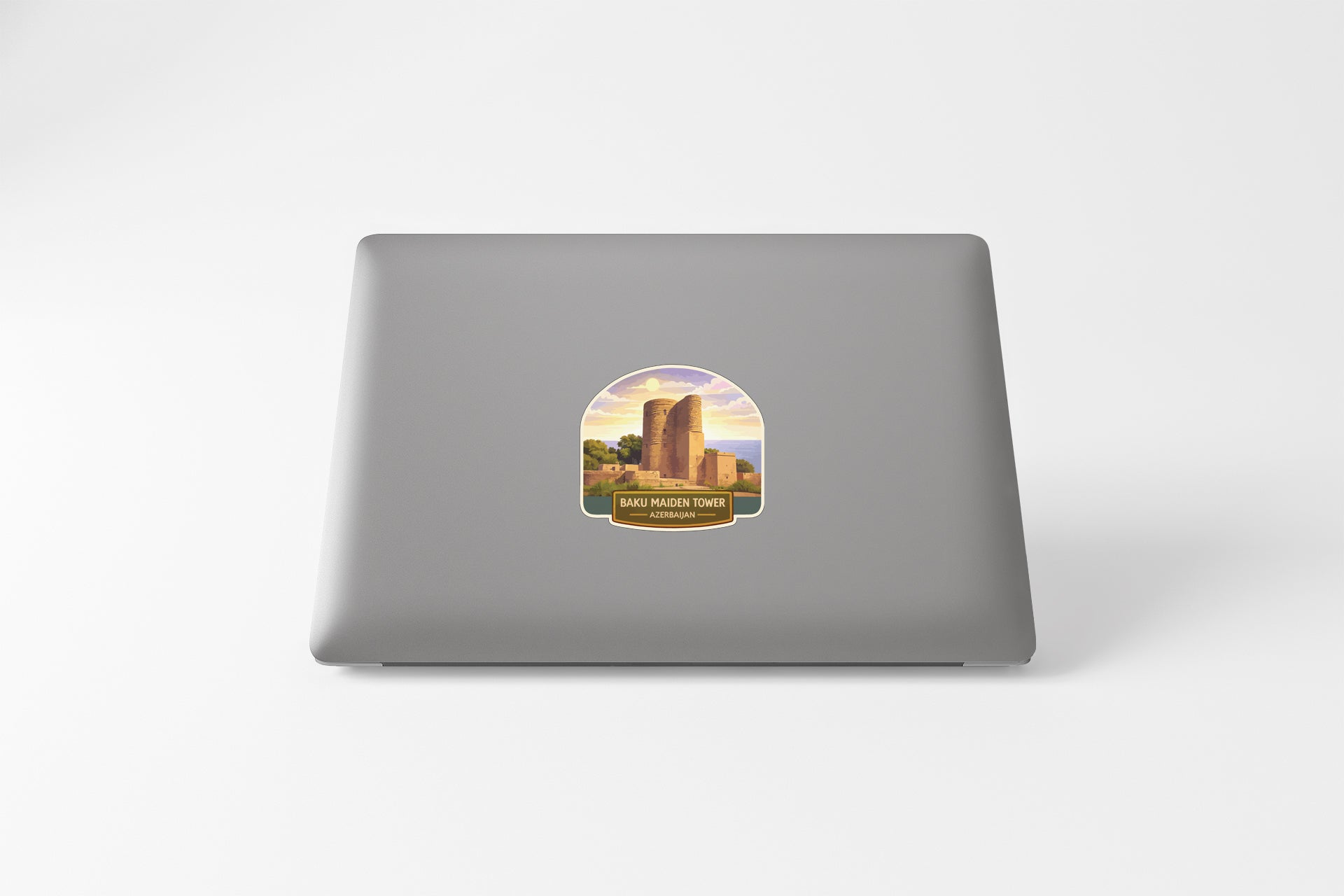 a sticker with a graphic of a building and the text "SABRE D'NENGO TOWER" on the back of a laptop.