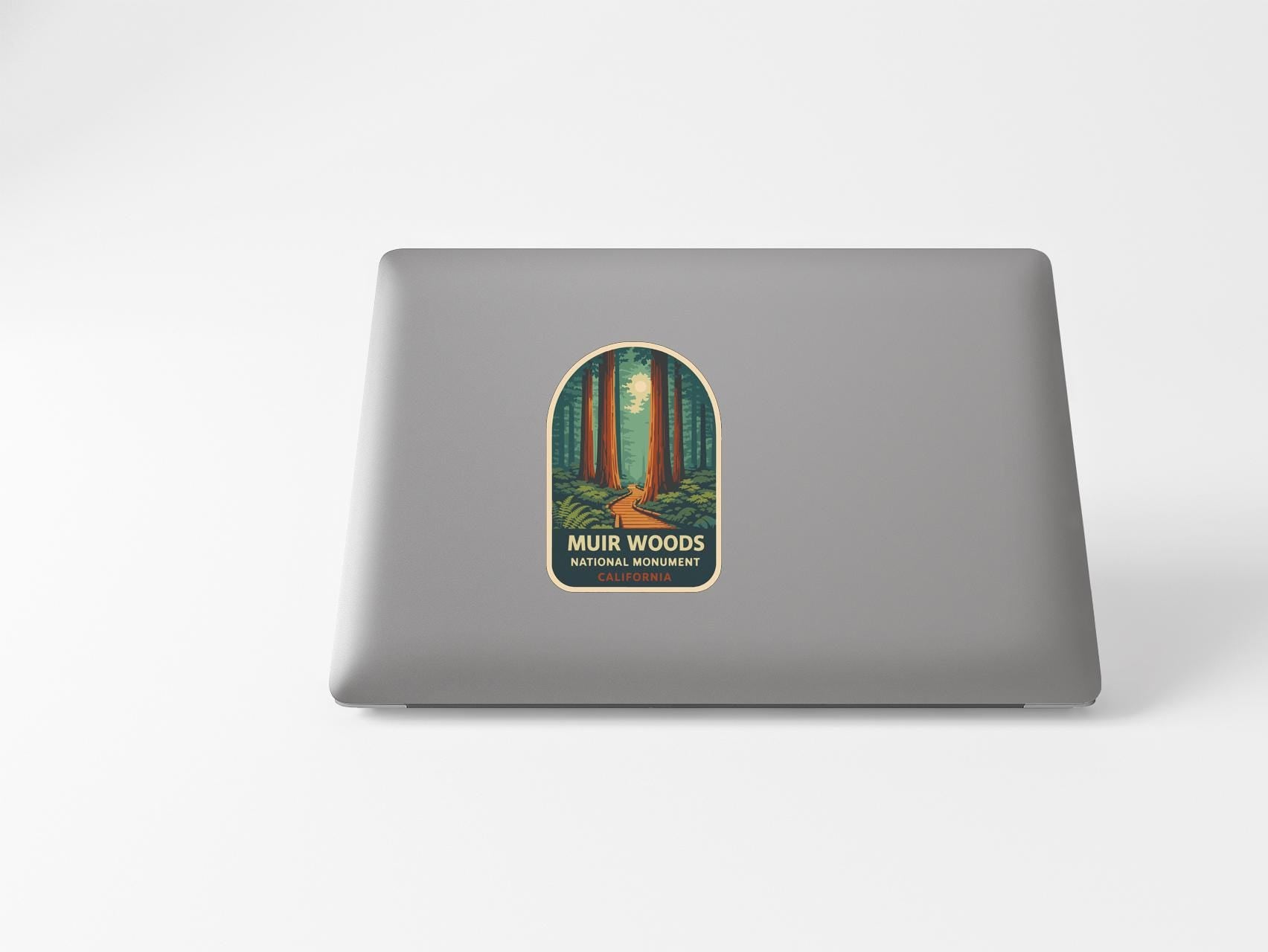 a sticker on the back of a laptop that says "MUR WOODS NATIONAL PARK".