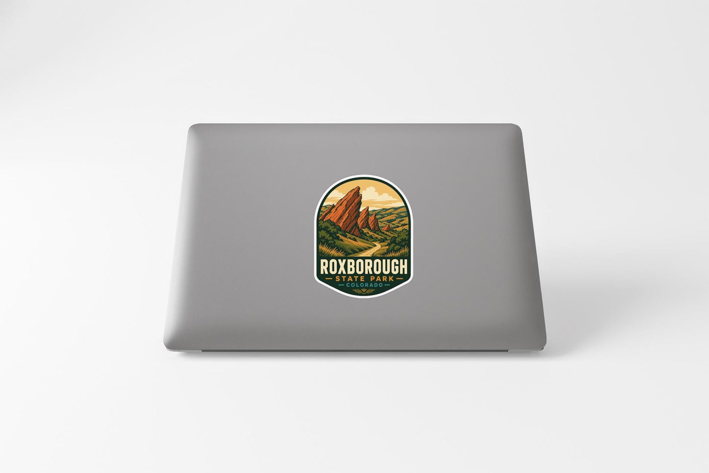 a sticker with a mountain landscape on a laptop.