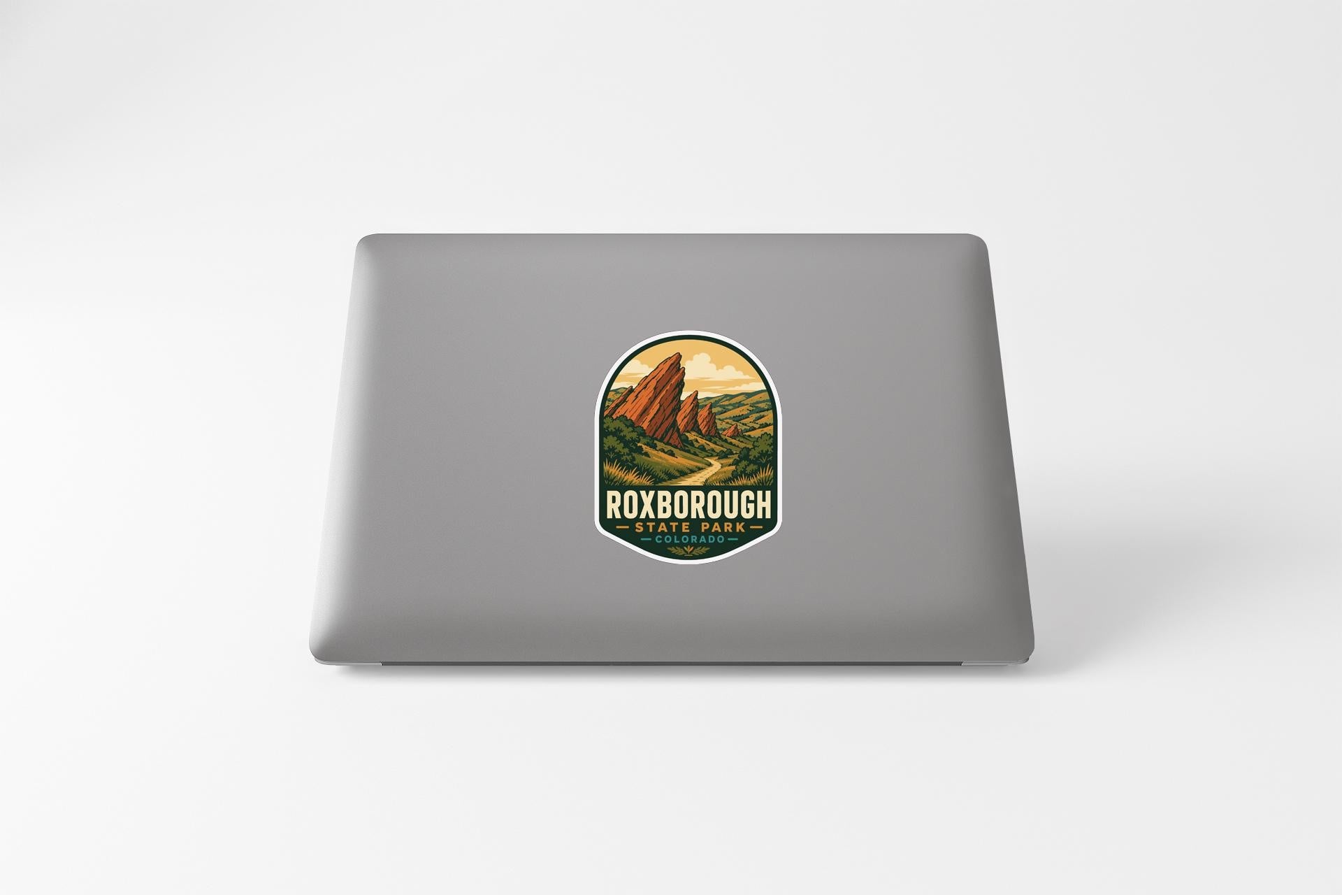 a sticker with a mountain landscape on a laptop.