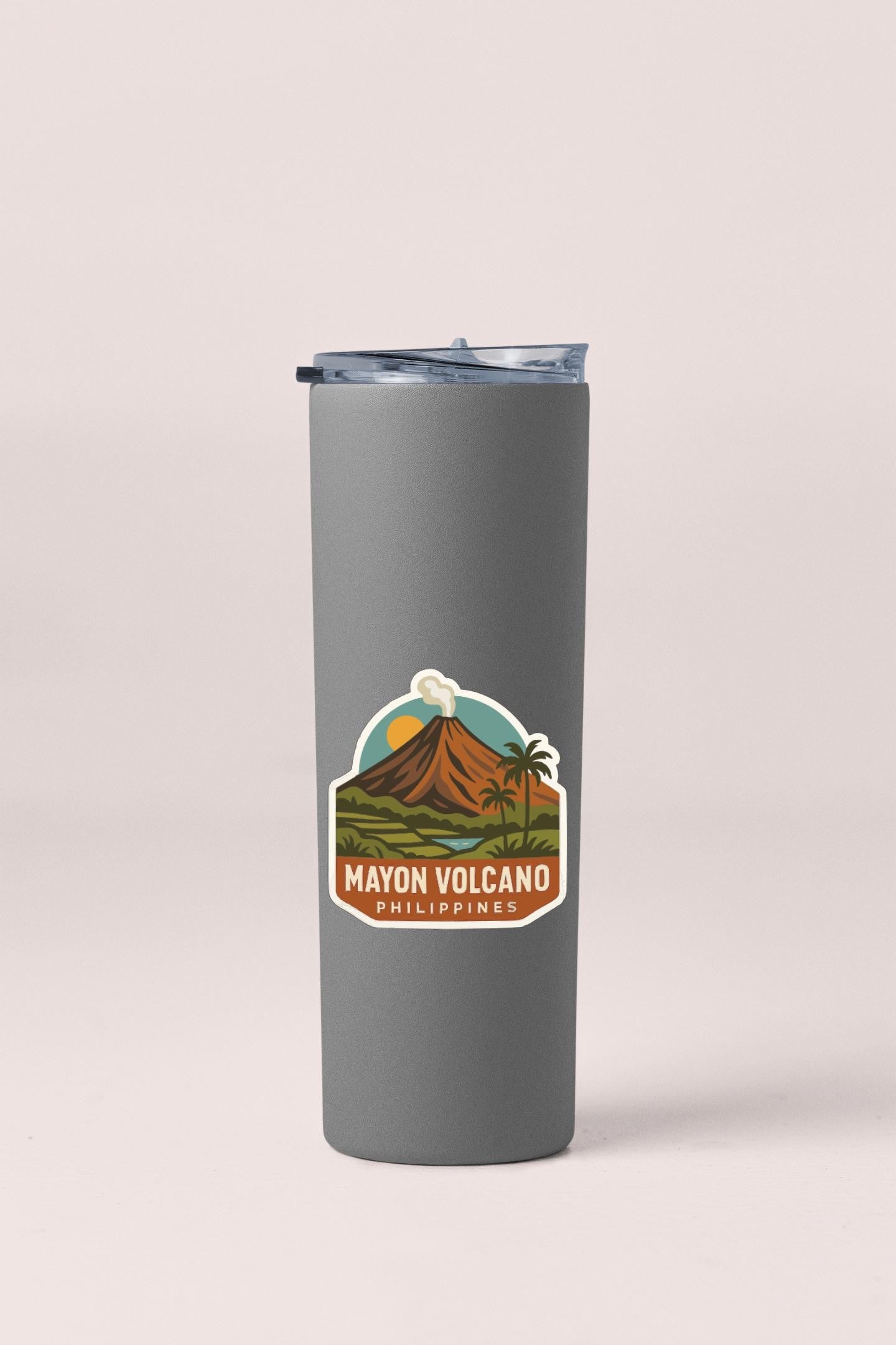 A gray insulated tumbler with a sticker depicting the Mayon Volcano in the Philippines.