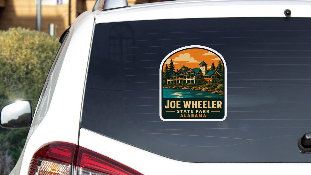 A sticker on the rear window of a white car, depicting a scenic landscape with a house and trees.