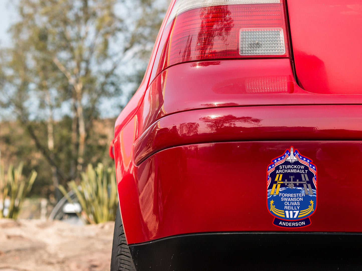 a close up of a red car with a badge on it