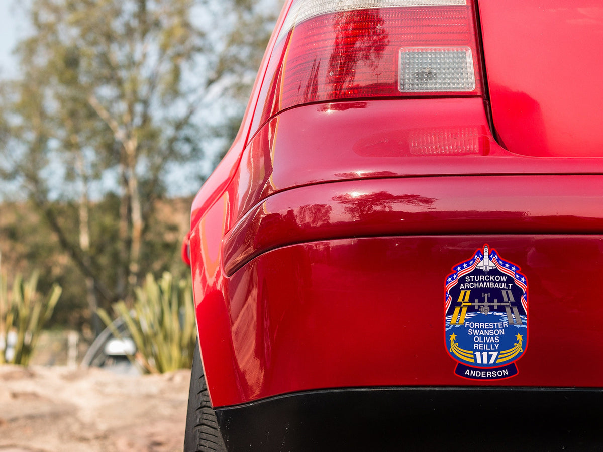 a close up of a red car with a badge on it