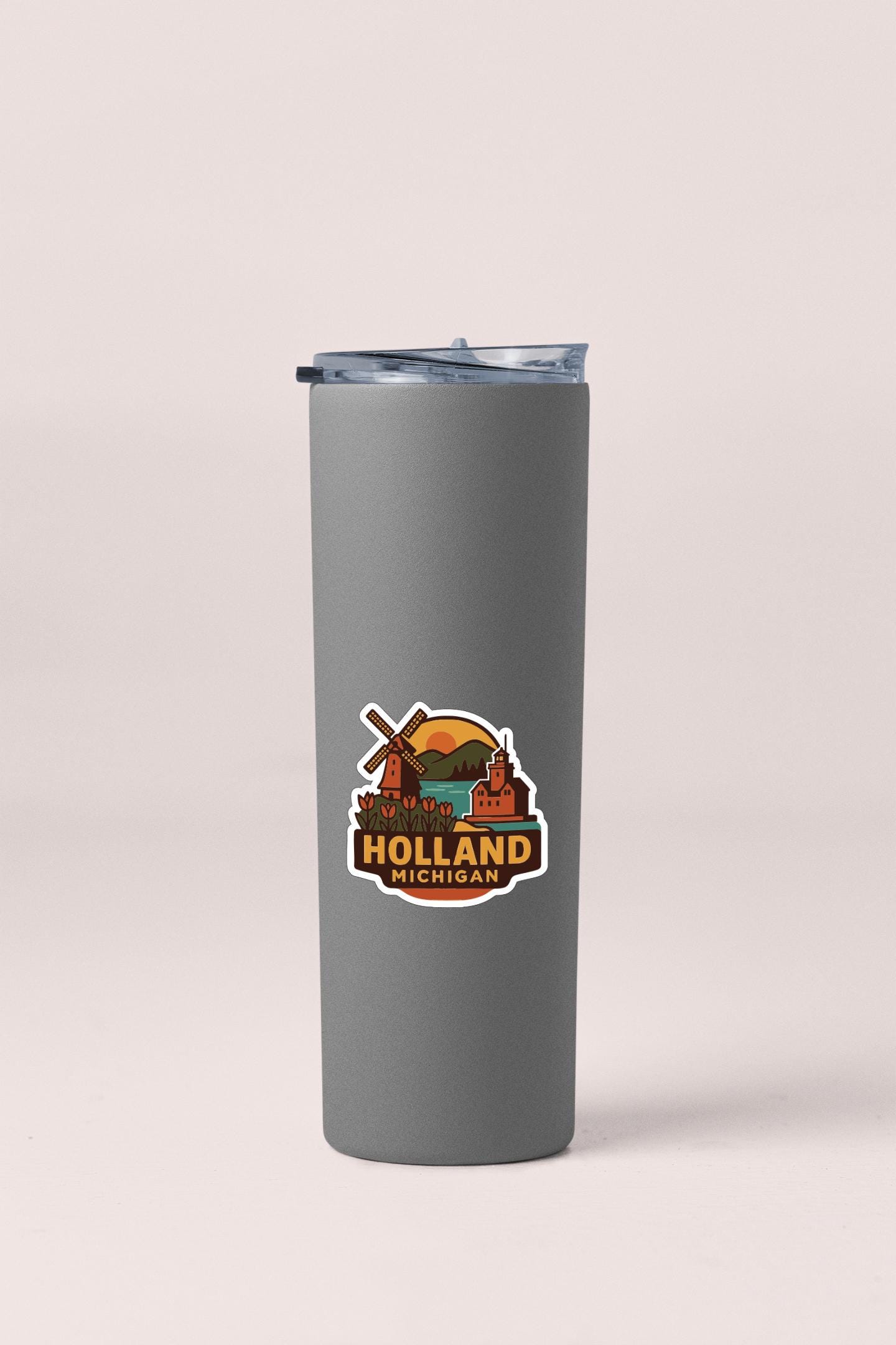 A gray insulated tumbler with a logo that says "Holland Michigan" on it.