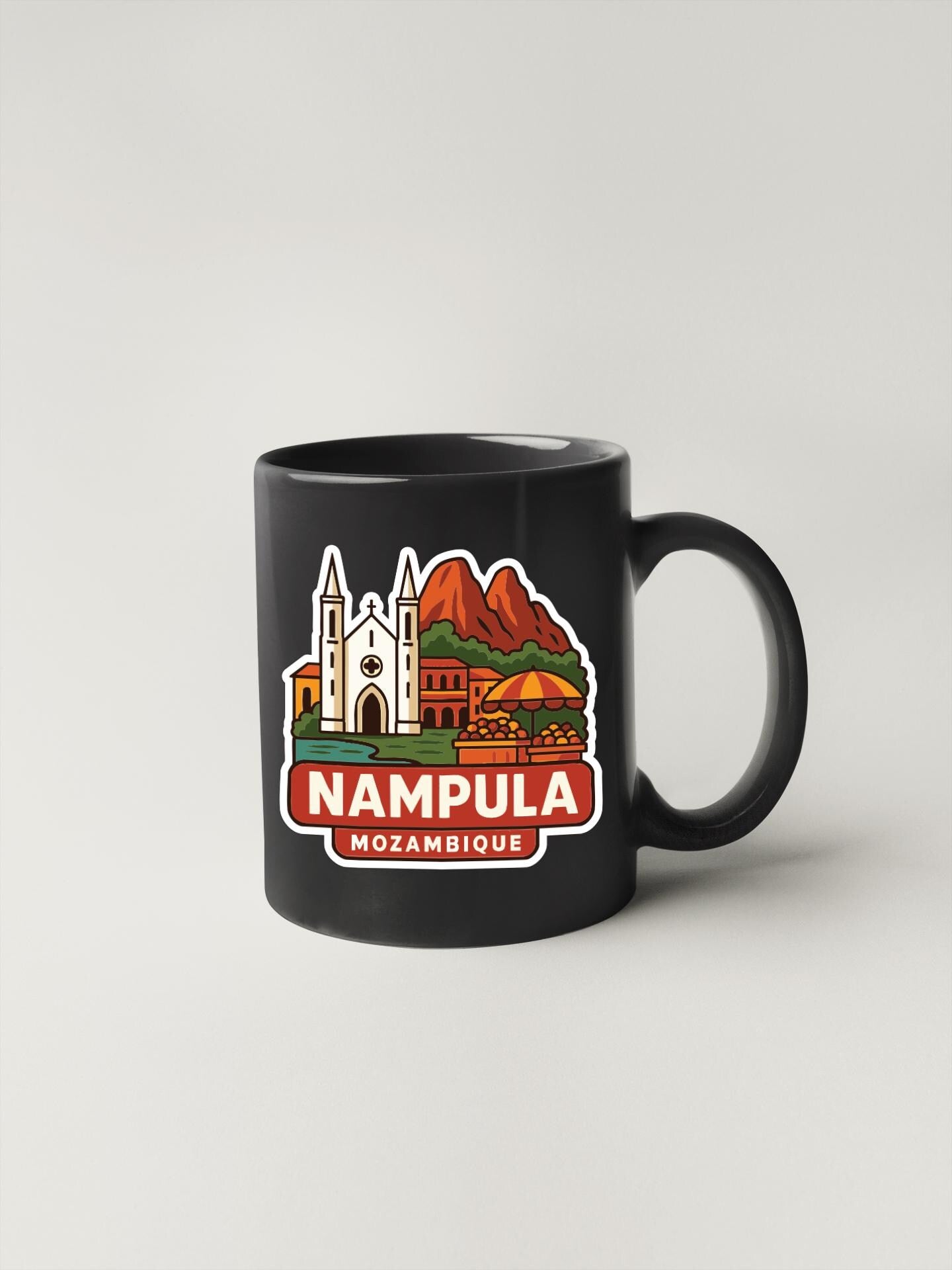 A black coffee mug with a colorful illustration of landmarks and buildings, along with the text "NAMPULA MOZAMBIQUE".
