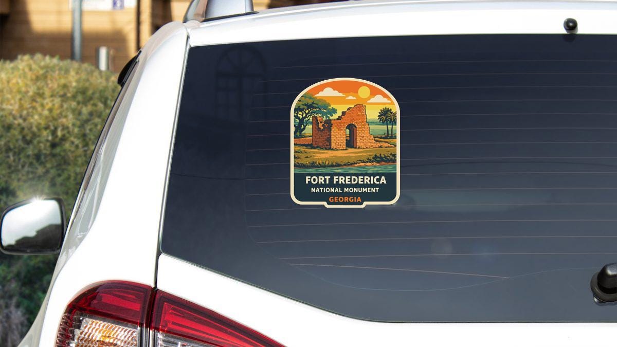 A sticker on the rear window of a white car, depicting a scenic landscape with a building and palm trees.
