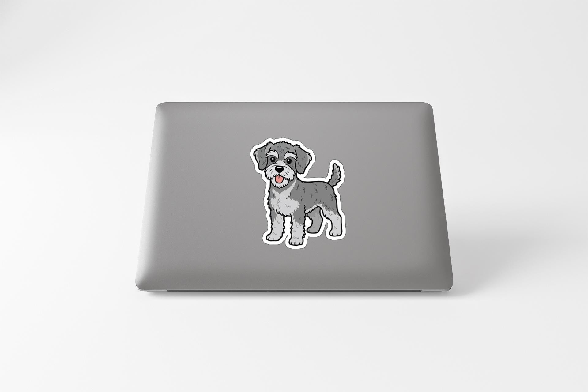 A sticker of a dog on the back of a laptop computer.