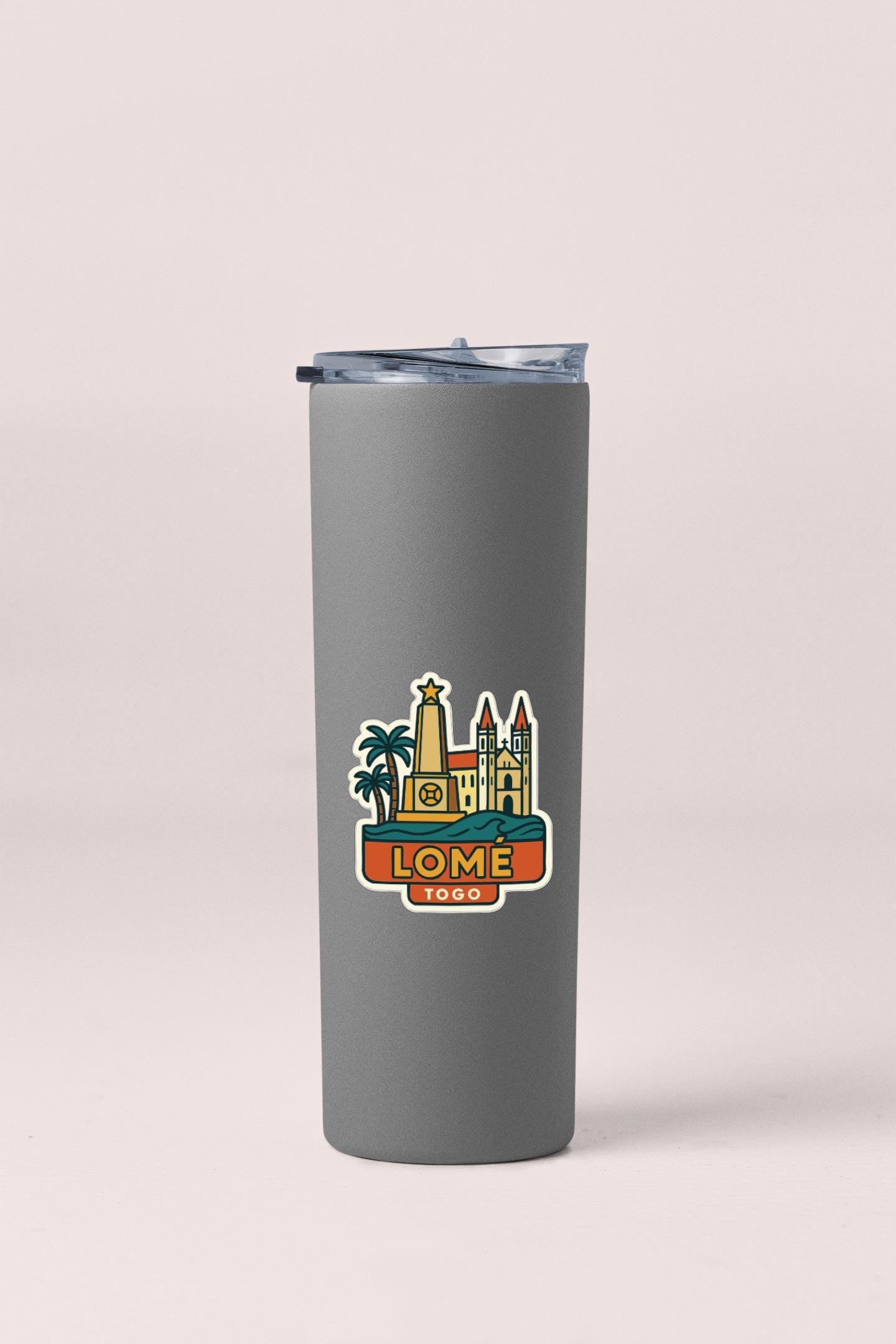 A gray insulated tumbler with a printed sticker depicting a city skyline.