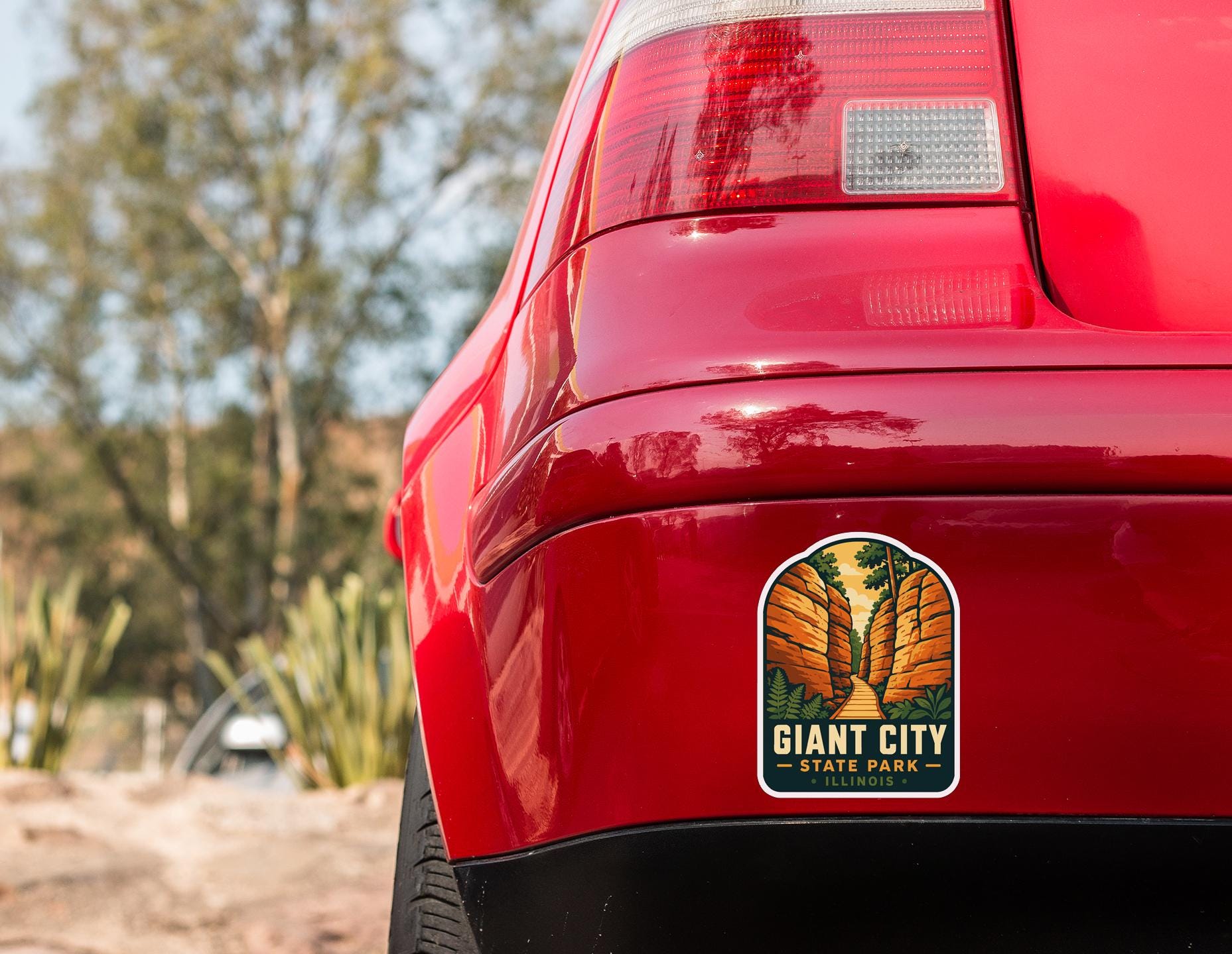 the rear end of a red car with a sticker on the trunk that says "Giant City State Park - Illinois".