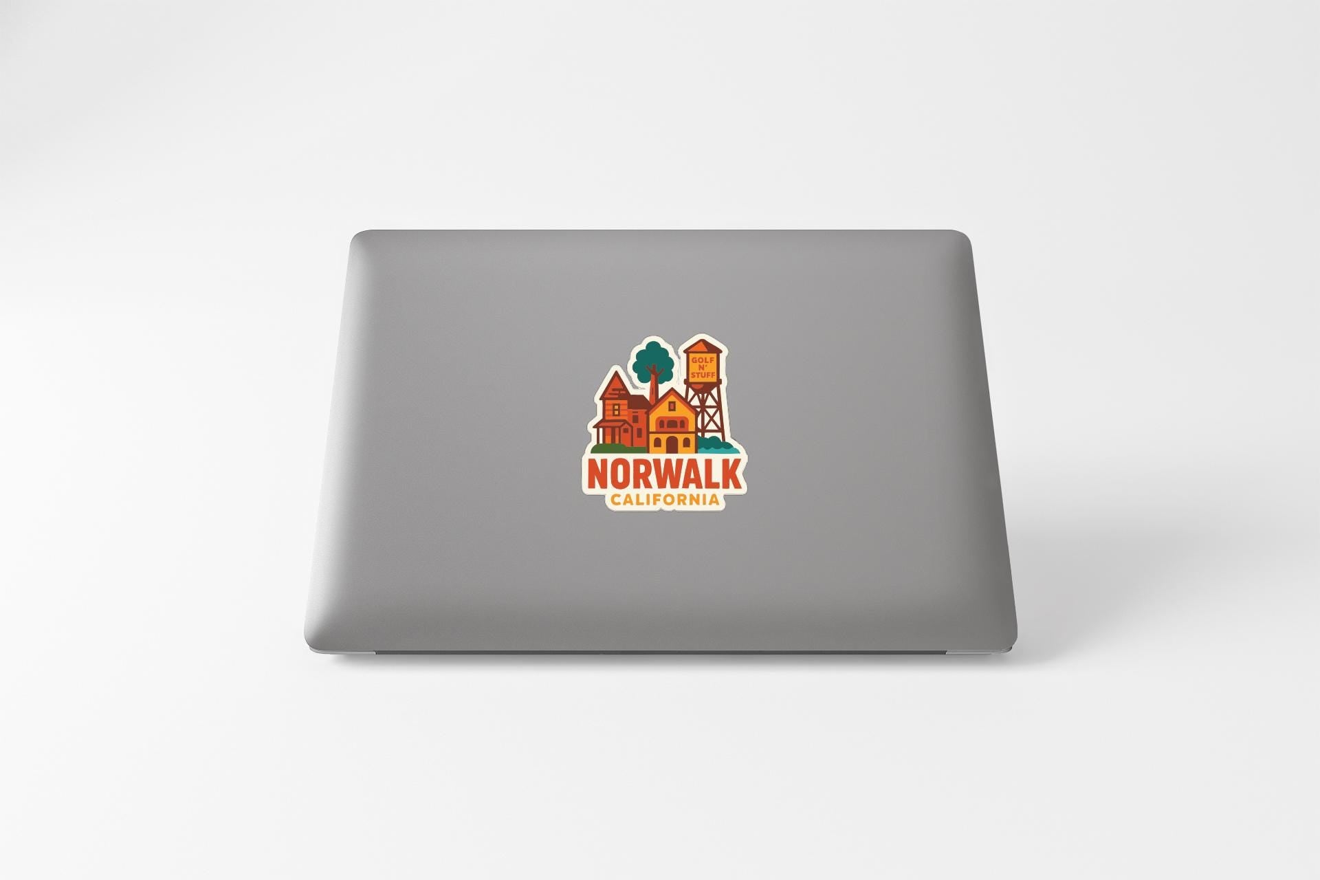 a sticker with a graphic of a house and the text "NORWALK CALIFORNIA" on the back of a laptop.