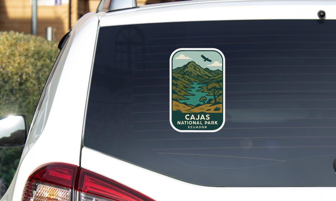 a sticker on the rear window of a white car, depicting a scenic landscape with mountains, a river, and a bird in flight.