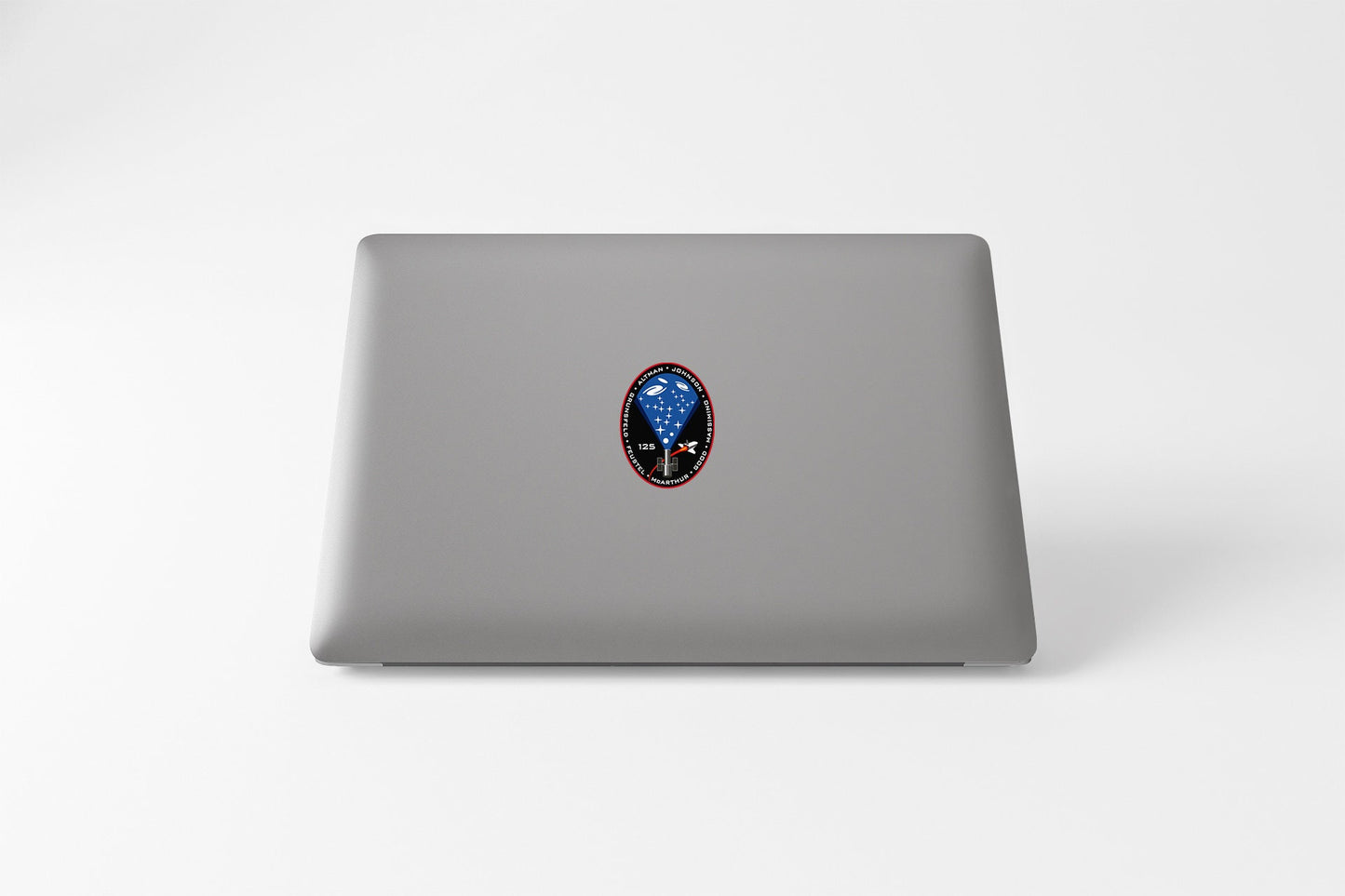 a laptop with a sticker of an alien head