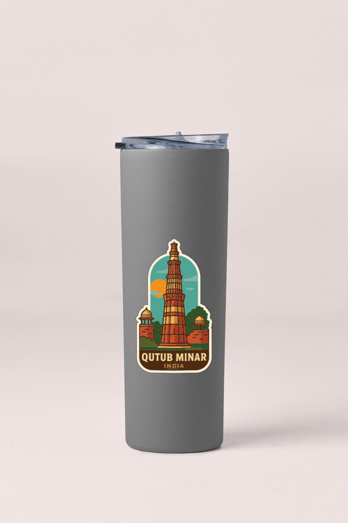 A gray tumbler with a sticker depicting the Qutub Minar, a famous monument in India.