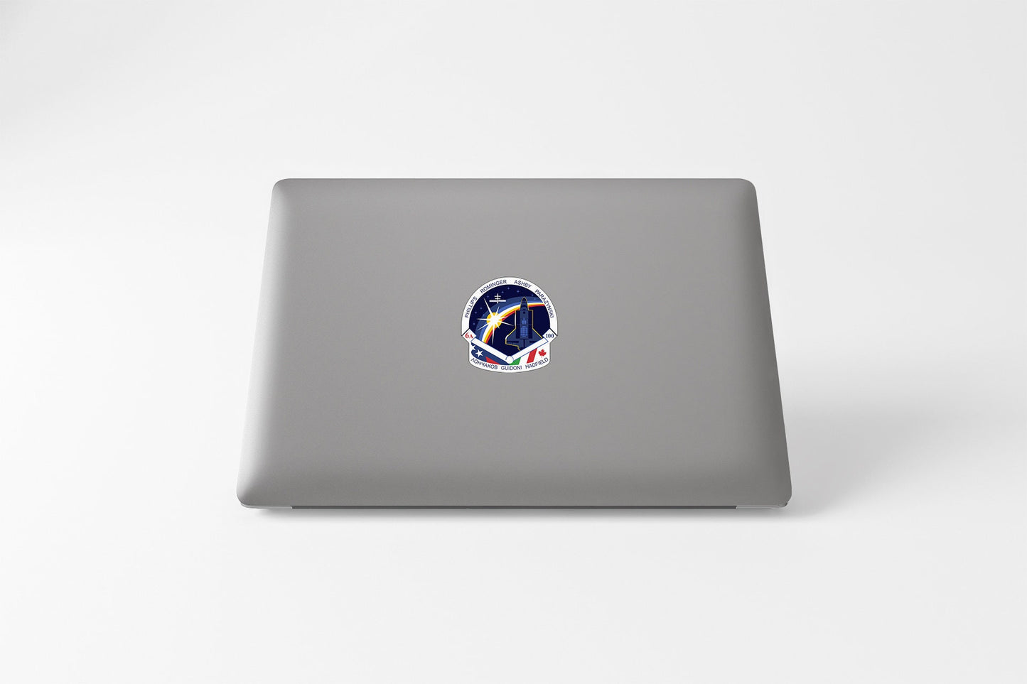 a laptop with a sticker of a space shuttle