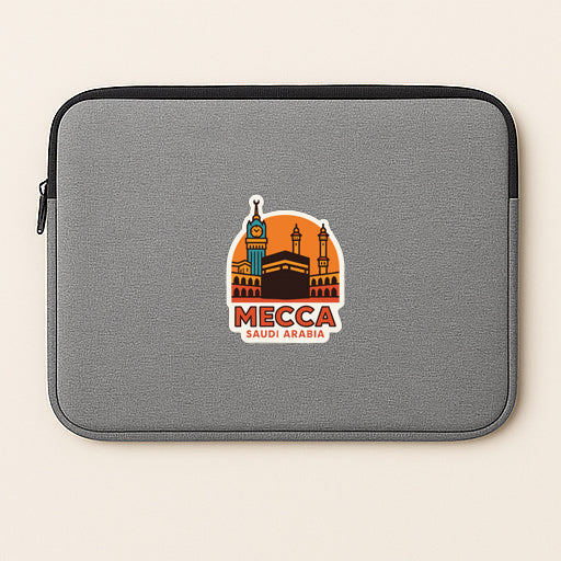 a gray laptop sleeve with a sticker depicting Mecca, Saudi Arabia.