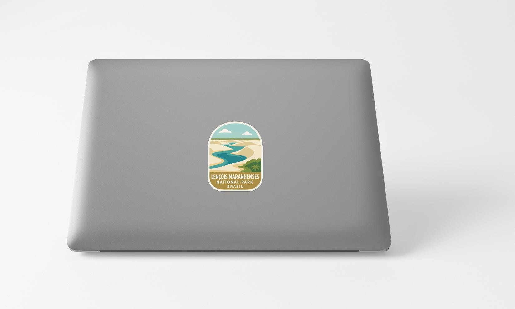 A sticker with a scenic landscape on a laptop.