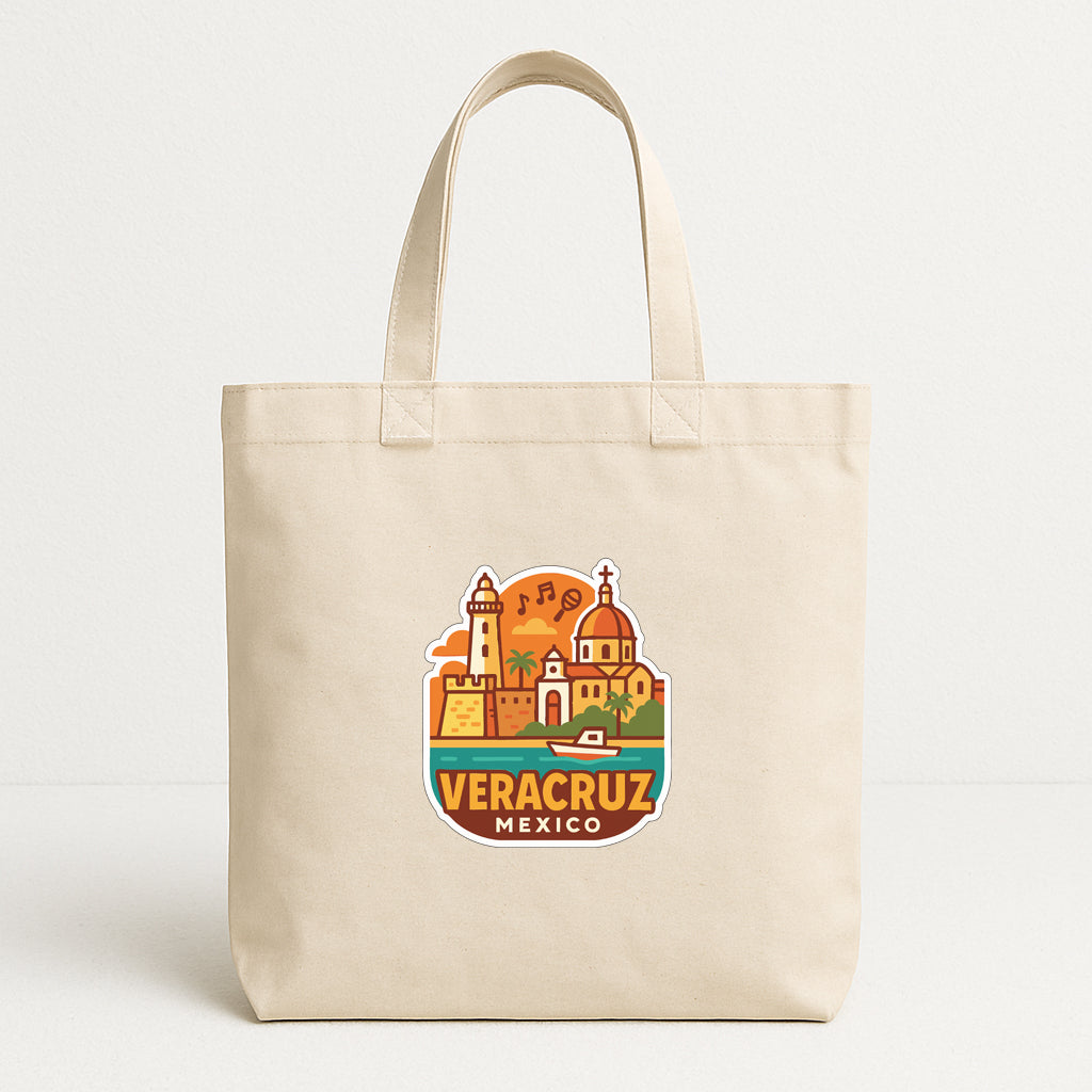 A beige tote bag with a printed design of a cityscape and the text "VERACRUZ MEXICO" printed on it.