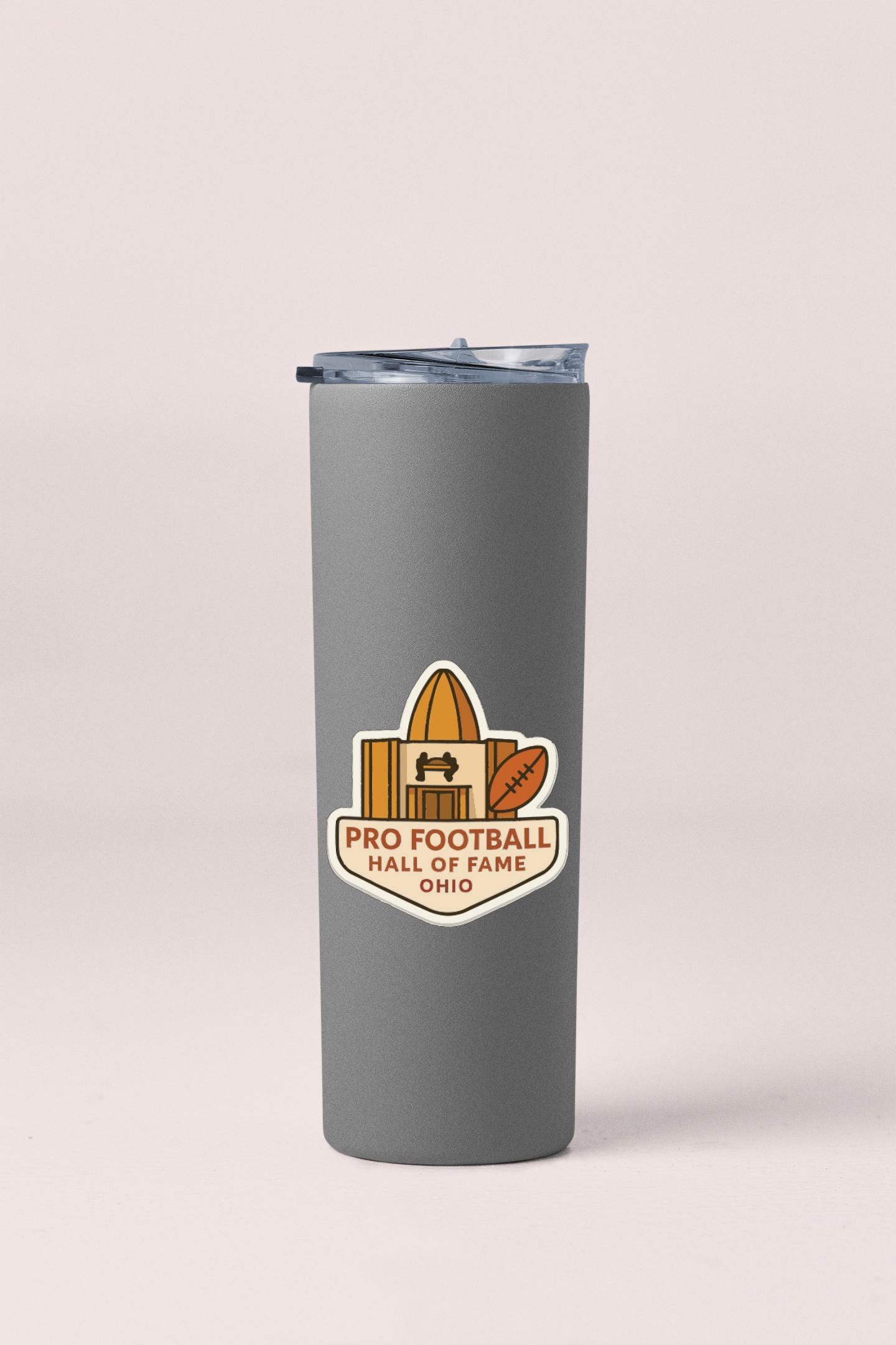 A gray insulated tumbler with a logo for the Pro Football Hall of Fame in Ohio.