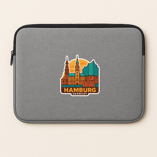 A gray laptop sleeve with a sticker of the city of Hamburg, Germany.