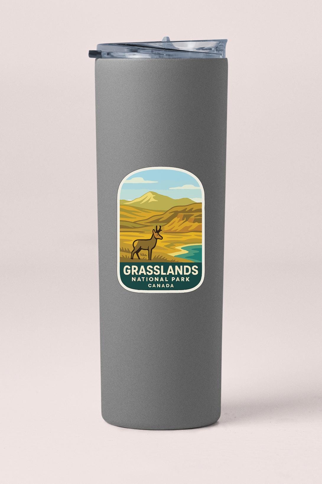 A gray cylindrical container with a label that features an illustration of a grassland landscape with a small animal, likely a deer or antelope, and the text "Grasslands National Park, Canada".