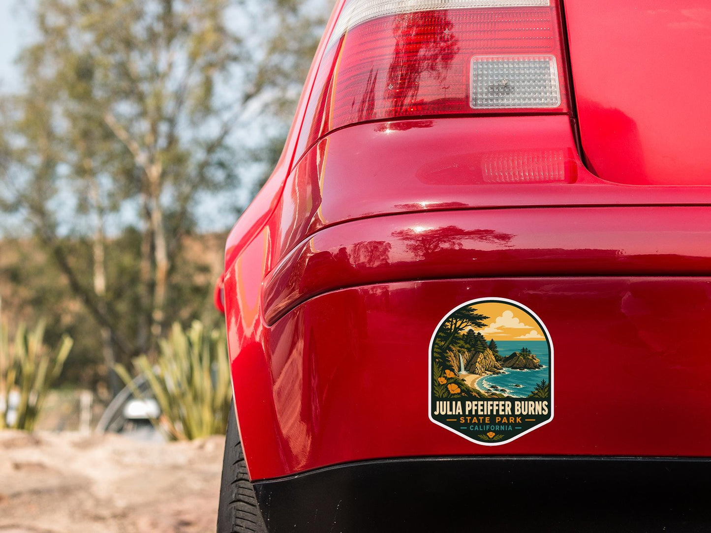 the rear end of a red car with a sticker on the back window that says "JULIA PFEFFER BIRNS STATE PARK".