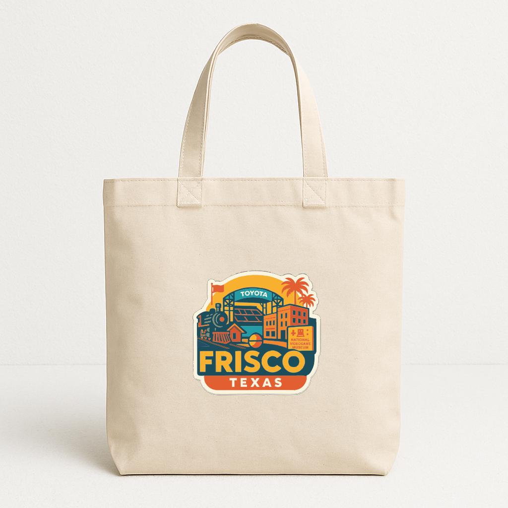 A beige tote bag with a colorful graphic of a cityscape and the text "FRISCO TEXAS" printed on it.