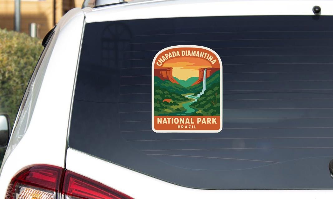 A sticker on the rear window of a car, depicting a scenic landscape with a waterfall and mountains, indicating that it is a sticker for Chapada Diamantina National Park in Brazil.