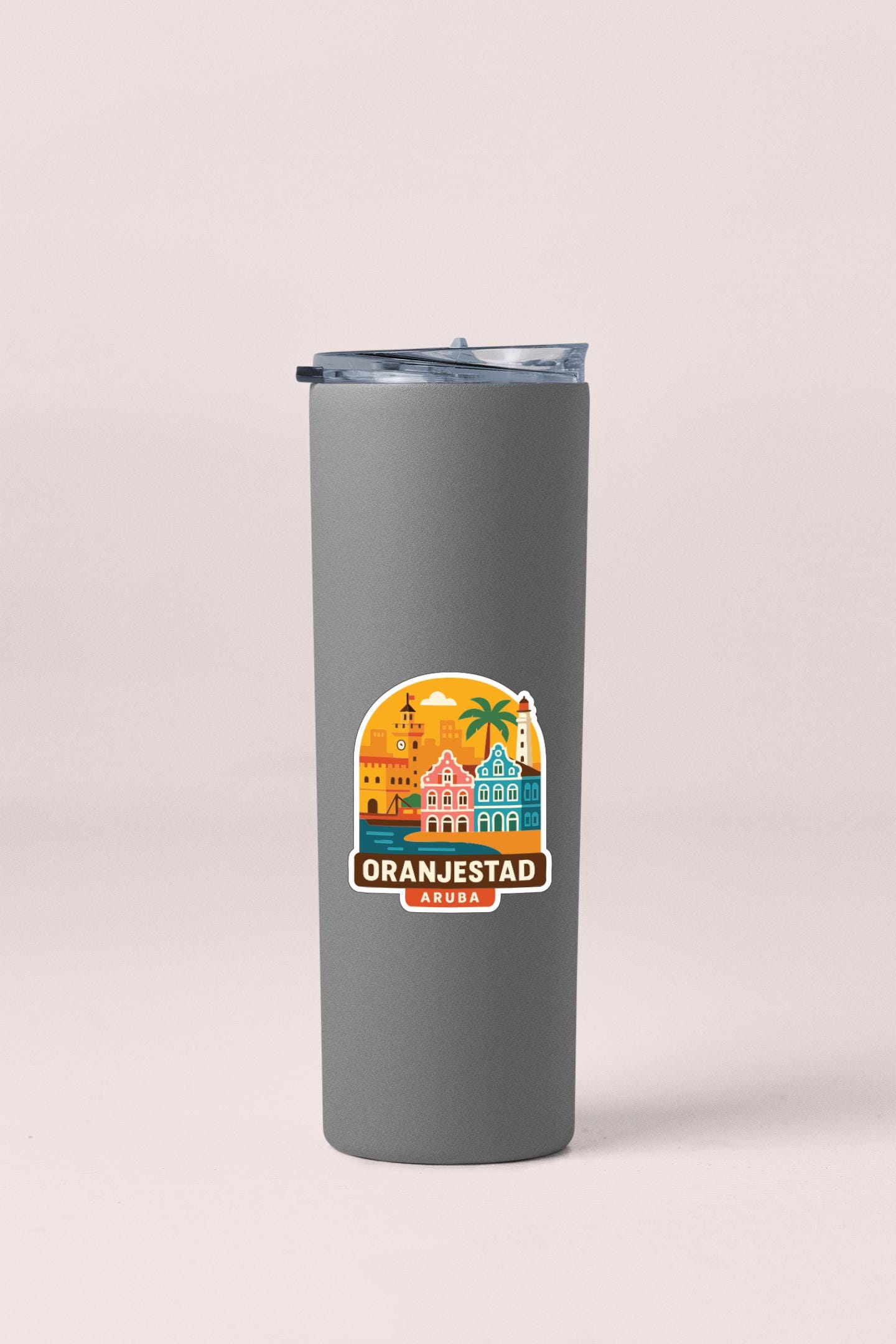 A gray insulated tumbler with a sticker depicting the city of Oranjestad, Aruba.